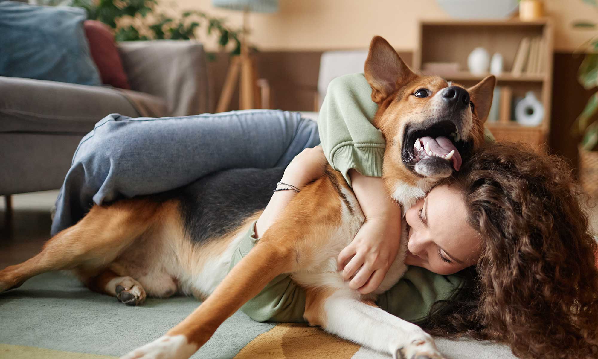 A woman playing with her dog