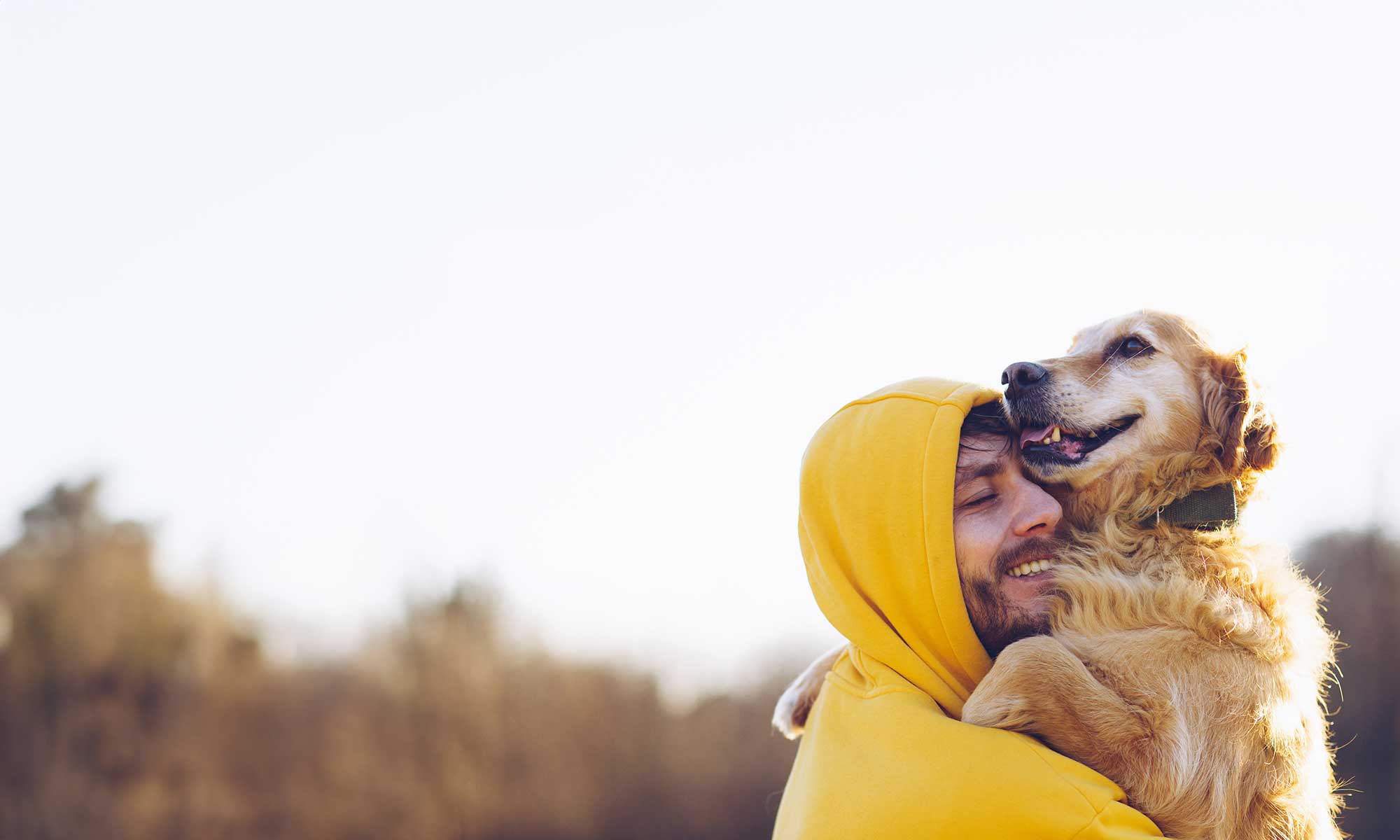 A man with his golden retriever outdoors